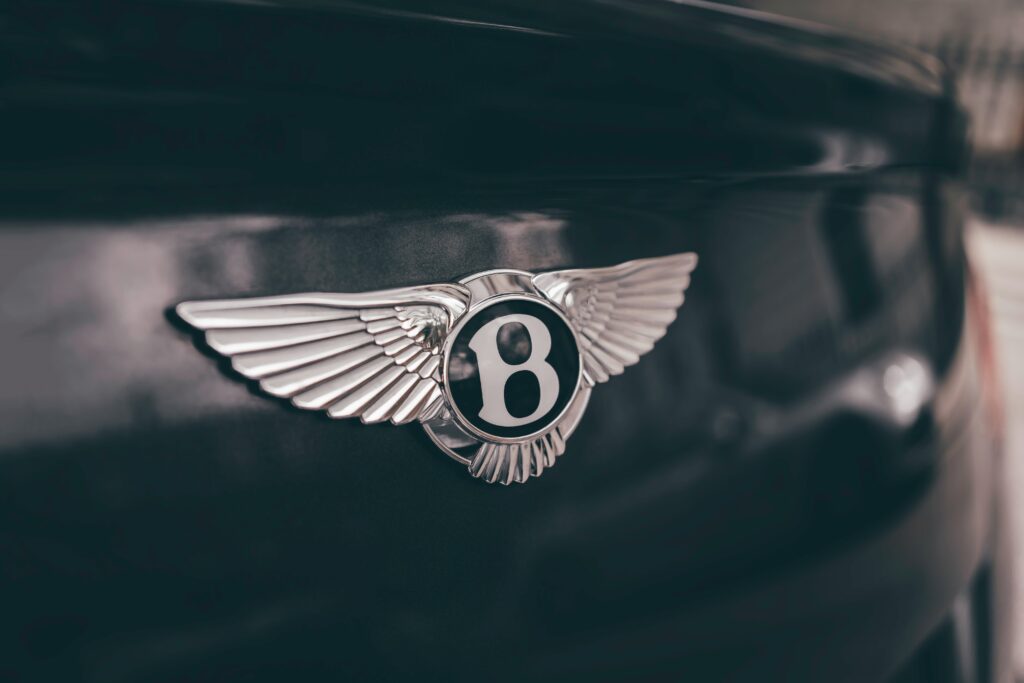 Bentley logo on a luxury car, symbolizing the brand’s prestige and the trust and credibility built through testimonials from high-end customers.