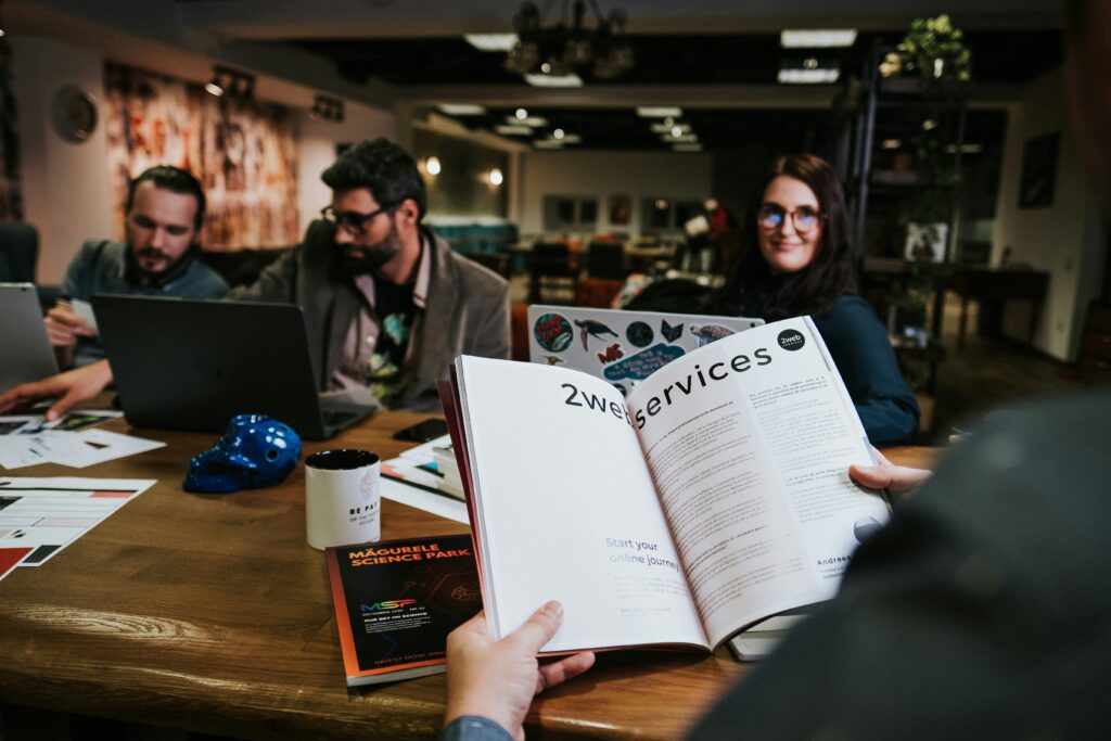 Customers interacting with a manager in a shop, with the manager holding a service book, highlighting enhanced customer experience.