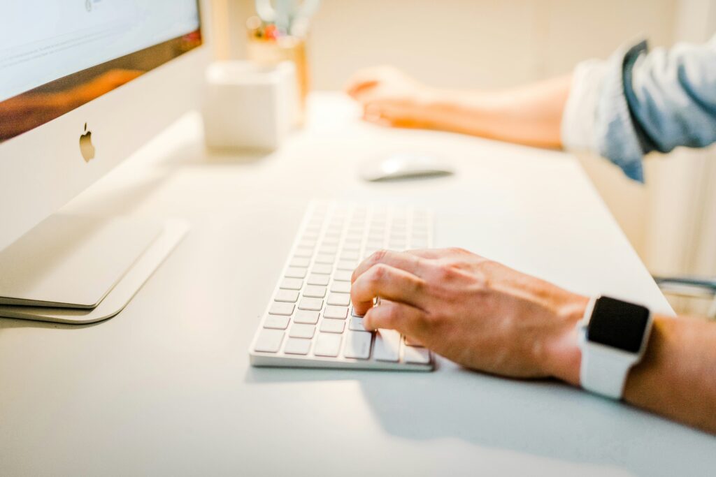 Person typing content on a laptop, representing HubSpot's approach to creating valuable marketing resources.