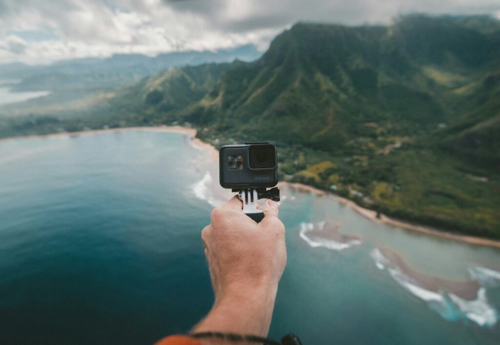 A person holding a GoPro camera, ready to capture action-packed footage.