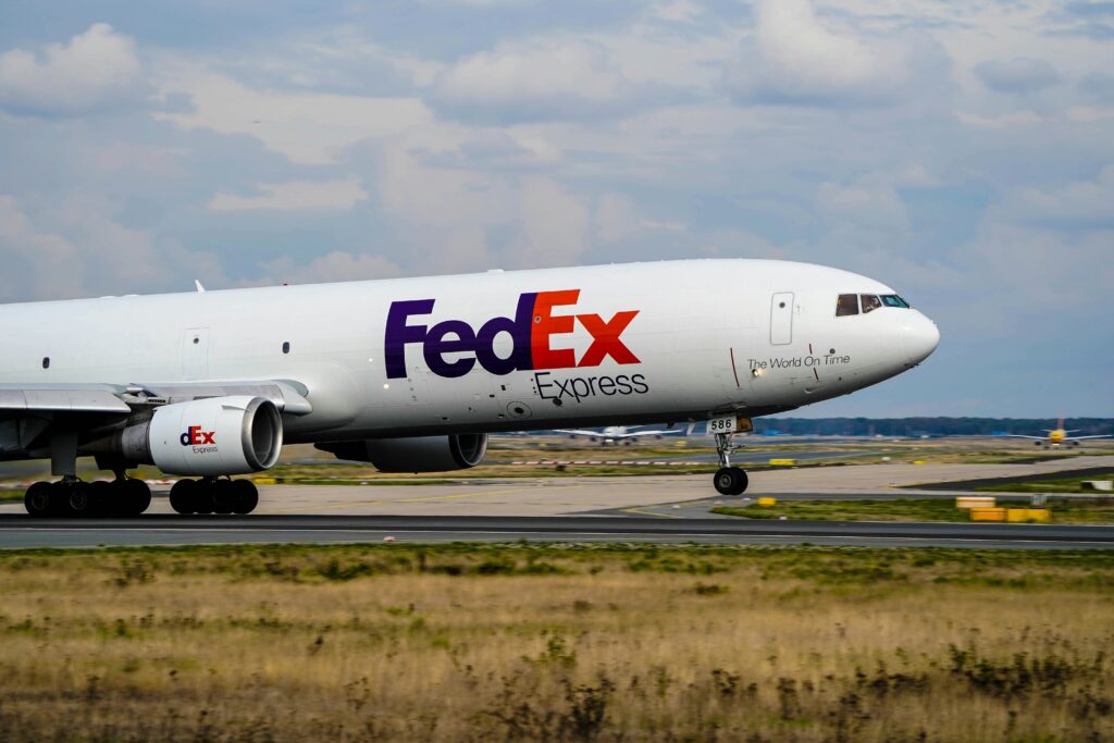 The FedEx logo showcasing the clever use of negative space to create an arrow between the letters "E" and "x," symbolizing speed and precision in delivery services.