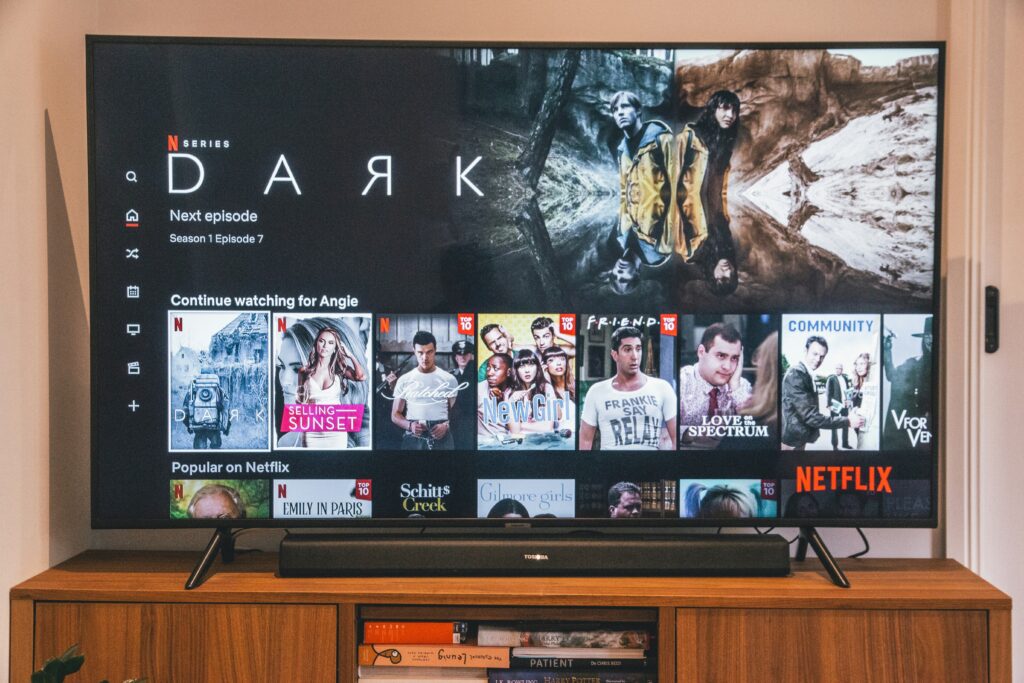 Netflix homepage on a TV screen displaying tailored recommendations for the user.