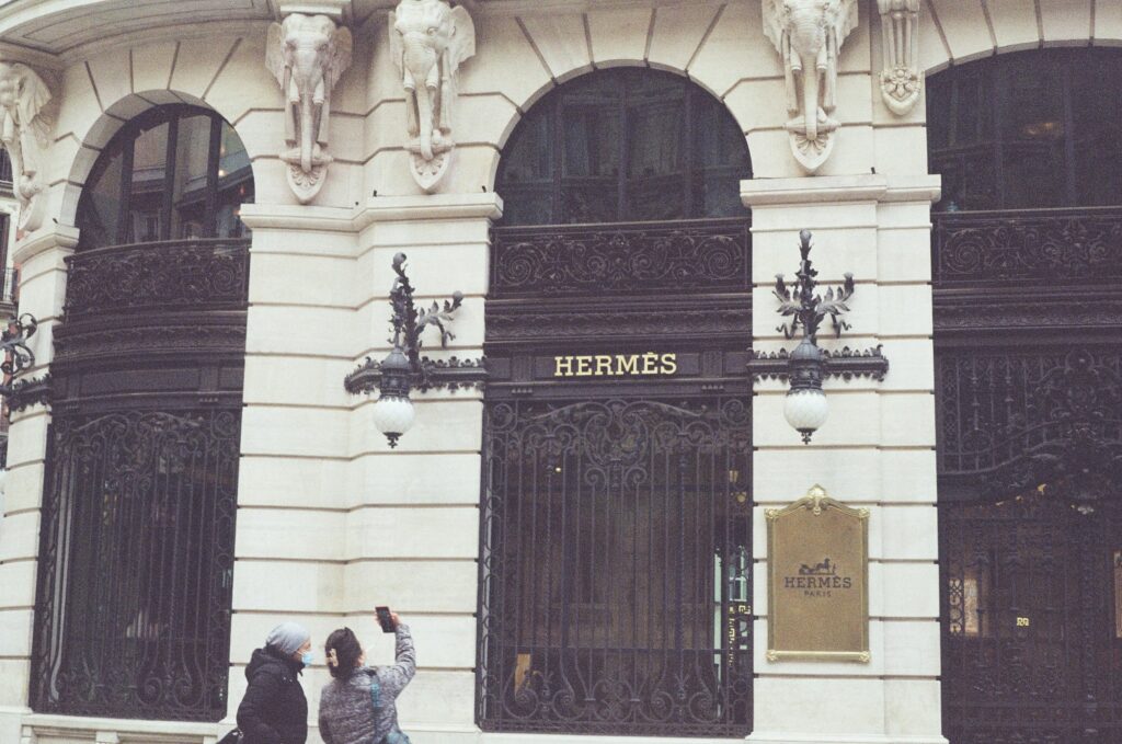 Hermès brand name store featuring the iconic Hermès logo displayed outside.