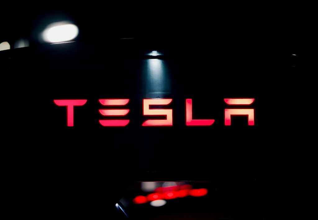 Tesla brand name logo representing innovation in electric vehicles.