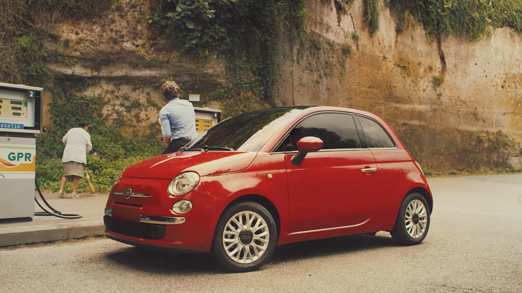 Fiat 500X car at a gas station with an elderly man