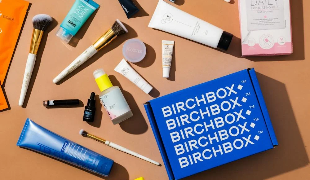 A collection of Birchbox products displayed in a subscription box, showcasing various beauty samples and items for customers to try.