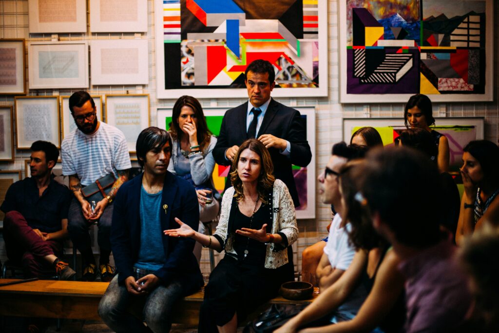 A discussion taking place in a conference room, with participants engaged in conversation about event marketing strategies.