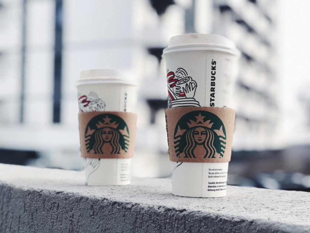 Two Starbucks cups demonstrating the Decoy Effect, showcasing a small cup, a medium cup, and a large cup with their respective prices.