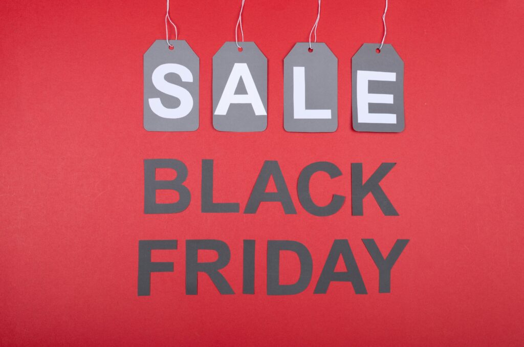 Black Friday Sale promotional image with bold text and shopping-related graphics.