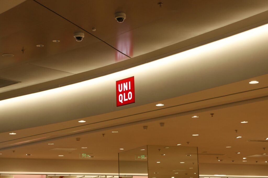 UNIQLO logo displayed on the exterior of a store, prominently featured above the entrance.