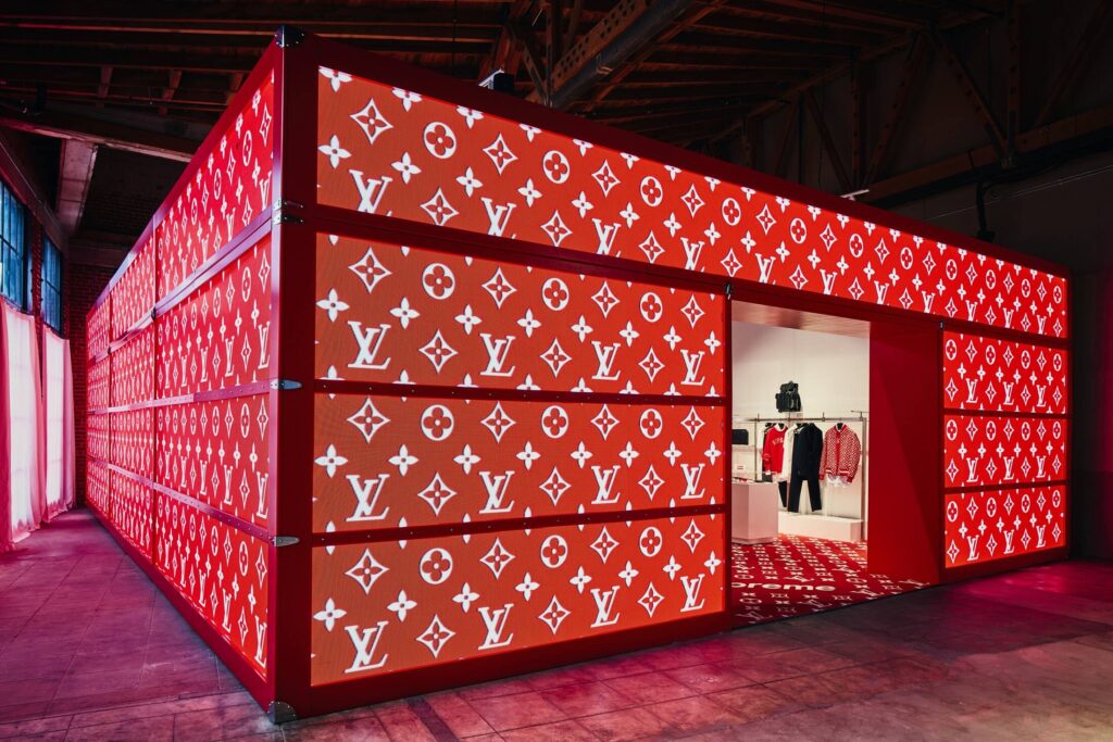 A Louis Vuitton x Supreme store featuring a fully themed interior with exclusive products on display.