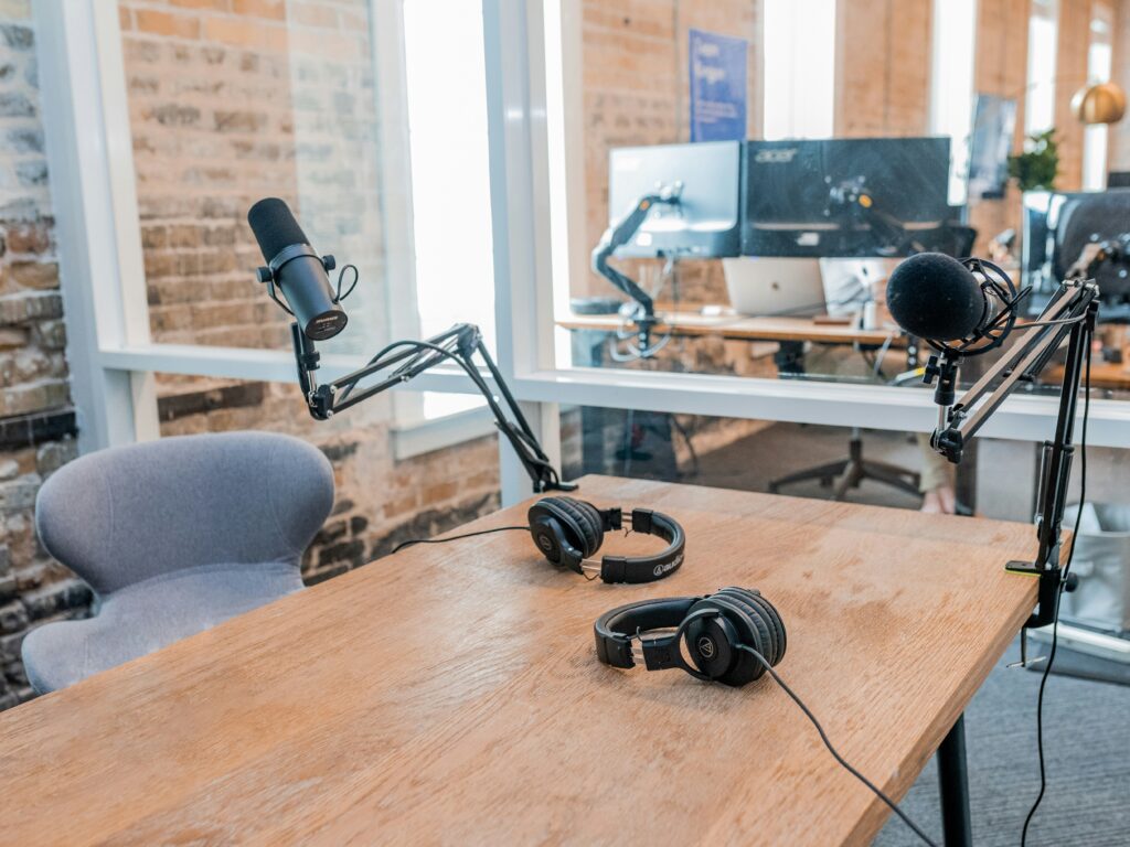 A well-organized podcast setup featuring microphones, headphones, and a table ready for recording.