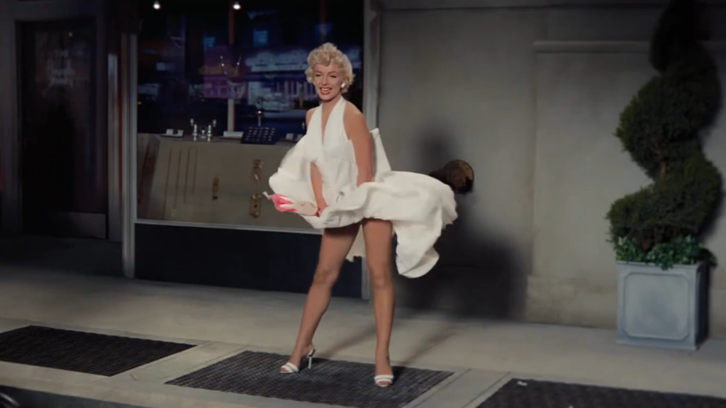 Willem Dafoe as Marilyn Monroe in the Snickers "Marilyn" Super Bowl ad, posing in the iconic white dress over a subway grate.