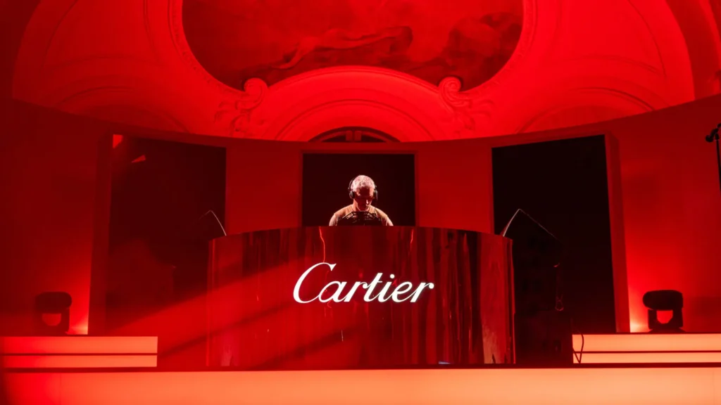 Cartier's exclusive event showcasing guests enjoying a luxurious dining experience under the stars, emphasizing digital branding strategies.